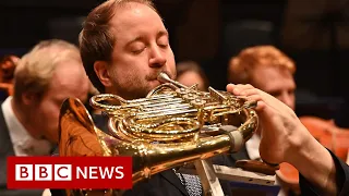 The musician who plays the French horn using his left foot - BBC News