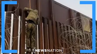 Reporter catches smugglers at U.S. border lowering migrants over fence | NewsNation