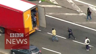 Moment Calais migrants jumped onboard lorries - BBC News