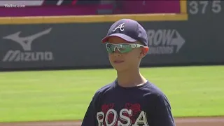 8-year-old cancer survivor throws first pitch at Braves game