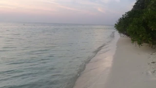Sunset in Thoddoo island. Amazing crystal water color. Indian ocean.
