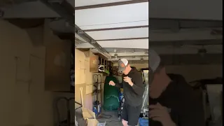 Guy panics over a bug and knocks his head on the garage door.