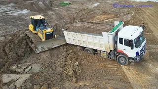 Bulldozer use his power helping ten wheel dump truck stuck - China dump truck unloading sand