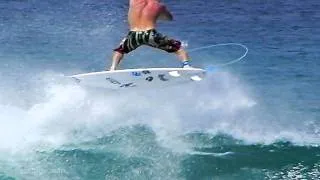 Mason Ho Lands an Air Reverse While Surfing at Rocky Point Hawaii