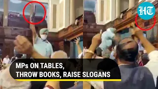 Parliament: MPs climb on top of tables, throw books, call it 'protest for farmers' as BJP slams