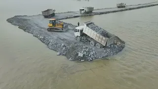 Nice Excellent Action Develop New Road on Big Lake by SHANTUI Bulldozer Pushing Rock , truck Unload