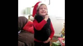 Little Girl Singing "We wish you a Merry Christmas"