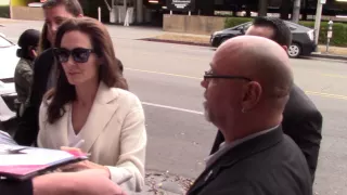 Sexy Angelina Jolie jokes with fans while signing autographs