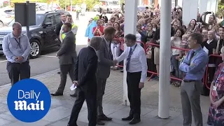 Prince Harry beams as he arrives at Oxford Children's Hospital