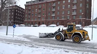 Big Volvo L90H Wheel Loader plowing snow after storm