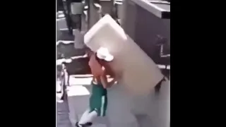 Crackhead rides bike while carrying a fridge