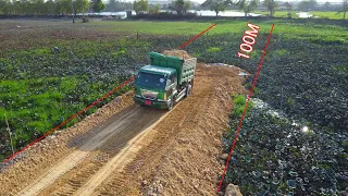 Process of pouring soil to build a road across the lake​, Mini Bulldozer MITSUBISHI & dump truck