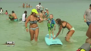 Kids with autism take surfing lessons