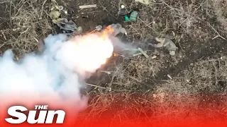 Russian soldiers catch fire as Ukrainian drones drop bombs on foxholes