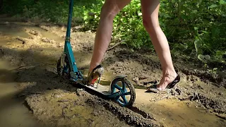 Girl in high heels on scooter in mud, high heels in mud, muddy louboutin, high heels stuck (# 774)