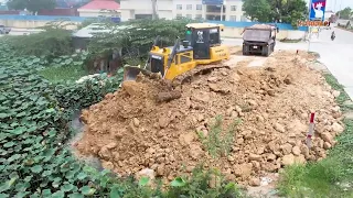 Great Job Landfilling Using Heavy Dump truck unloading soil and operator Bulldozer pushing soil