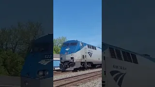 Amtrak P063 races up the rear of a CSX manifest