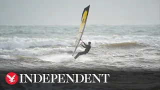 People kite and windsurf on Avon Beach as Storm Gerrit hits UK