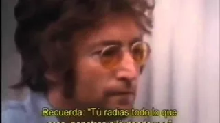 John Lennon talks to a hippie who had been camping out on his lawn