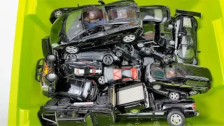 A box full of various black cars