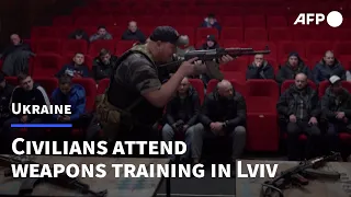 Ukrainian civilians attend weapons training in former film centre | AFP