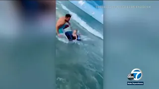 Boy escapes close encounter with shark thanks to police officer