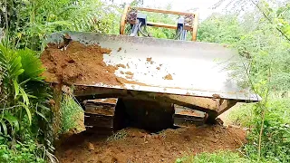 D6R XL Bulldozer Operator Works to Repair Damaged Roads on the Riverside