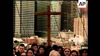 Pope Benedict XVI carried a tall, plain cross in the traditional Good Friday Colosseum procession to