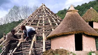 CIRCULAR PRIMITIVE HUT by hand. Traditional construction of an Iron Age VILLAGE