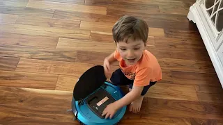 Playing with his robot vacuums