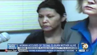 Not guilty plea from woman accused of trying to push mother into burning home