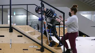 Paraplegic Person Climbs Stairs With Exoskeleton