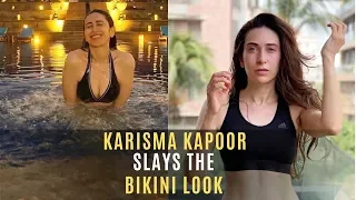 Karisma Kapoor Splashes Around In The Pool In Black Bikini | SpotboyE