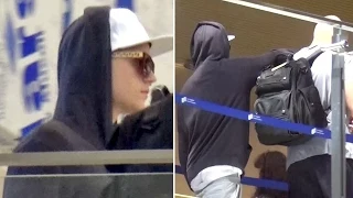 EXCLUSIVE - Blonde Justin Bieber Looks Tired, Leans On Bodyguard At LAX