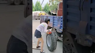 Respect! The hard-working woman changes tires so well.