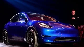 Elon Musk rolls out Tesla's new Model Y amid challenges.