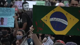 Brazilians protest Bolsonaro, recreate George Floyd death | AFP