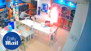 Shocking moment tumble dryer catches fire in Thailand