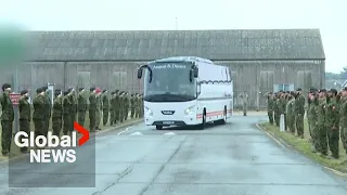 Canadian troops salute Ukrainian recruits departing for war