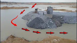 Great Development In lake Bulldozer pushing big stone into water