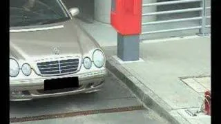 Woman driving car out of parking garage