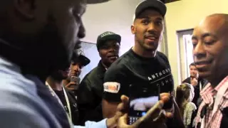 KEVIN JOHNSON BANTERS WITH ANTHONY JOSHUA IN THE CORRIDOR AS PAIR MEET AFTER WEIGH-IN .