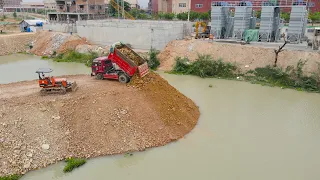 Incredible Waterfront Landfill Run by a Bulldozer with Surrounding Soil a processing bottleneck