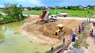 Full process with experts working the soil into the water near the fence | 5 ton trucks