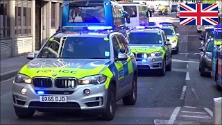 Convoy of three armed police cars responding with siren and lights