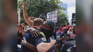 Touching moment between HPD officer and protester