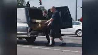 Body in cardboard coffin falls out of hearse