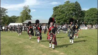 Drum Majors lead the massed Pipe Bands afternoon march during 2023 Oldmeldrum Highland Games