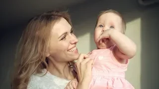 Happy Mother Holding Baby Girl on Hands. Cheerful Mom Embrace Toddler Girl | Stock Footage -