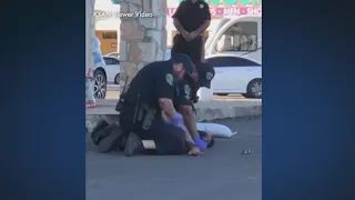 Viewer video shows APD officer punching woman several times as she's restrained on the ground.